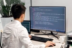 back view shot of a man working on his computer